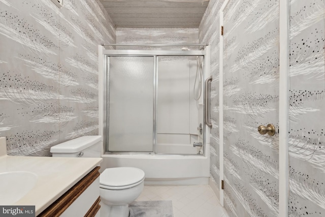 full bathroom featuring toilet, vanity, shower / bath combination with glass door, and tile patterned flooring