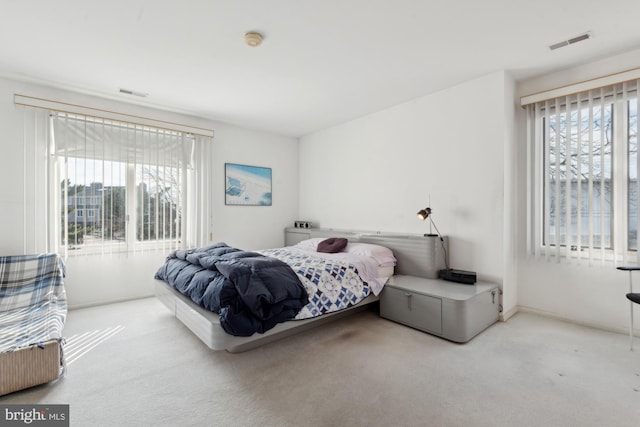 bedroom with light colored carpet