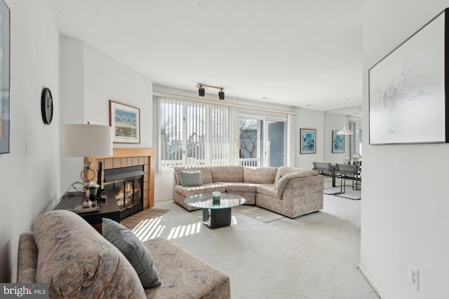 living room featuring carpet floors and a tile fireplace