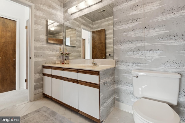 bathroom featuring vanity, toilet, and tile patterned flooring