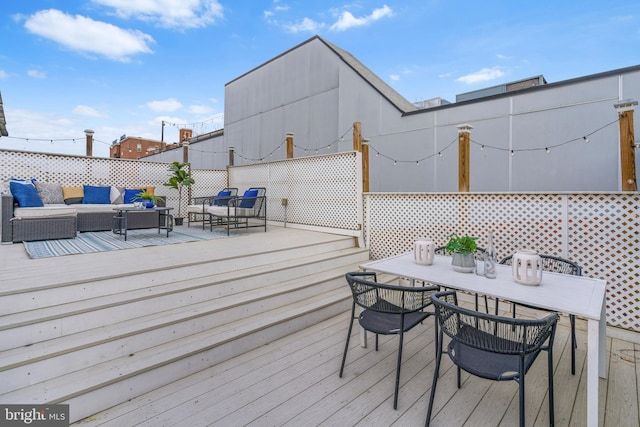 wooden terrace featuring an outdoor living space