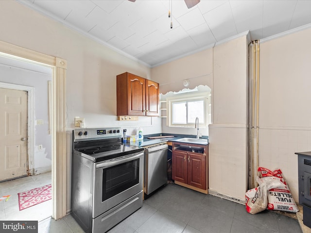 kitchen with stainless steel appliances, crown molding, and sink