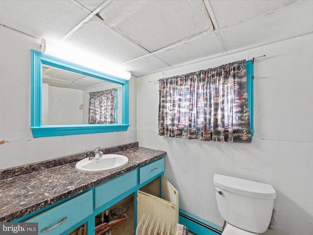 bathroom with vanity, a paneled ceiling, and toilet