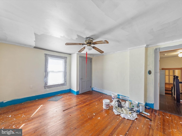 unfurnished room with crown molding, ceiling fan, and dark hardwood / wood-style floors