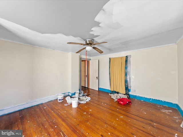 interior space with crown molding, wood-type flooring, and ceiling fan