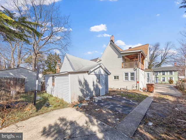 back of property featuring a balcony