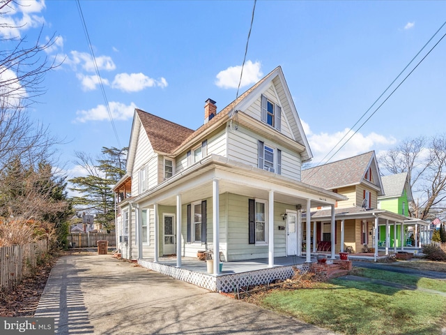 view of front facade featuring covered porch and a front yard