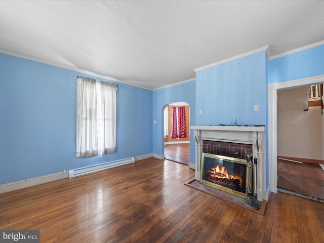 living room with crown molding, a fireplace, wood-type flooring, and baseboard heating