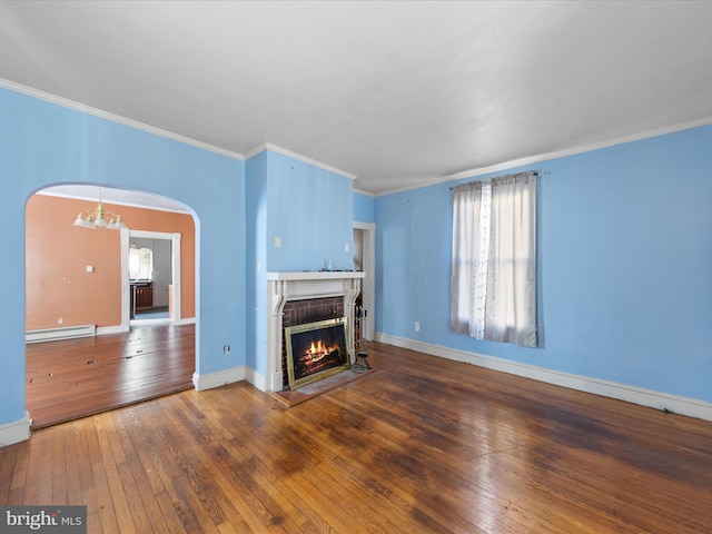 unfurnished living room with crown molding, a brick fireplace, a baseboard heating unit, and dark wood-type flooring