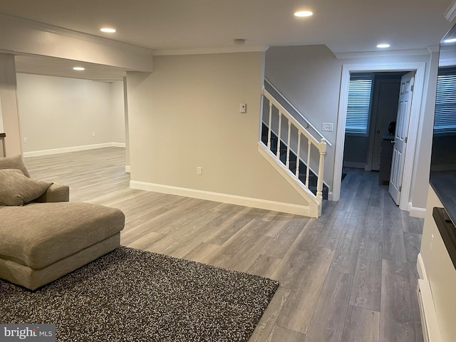 living room with wood-type flooring and ornamental molding