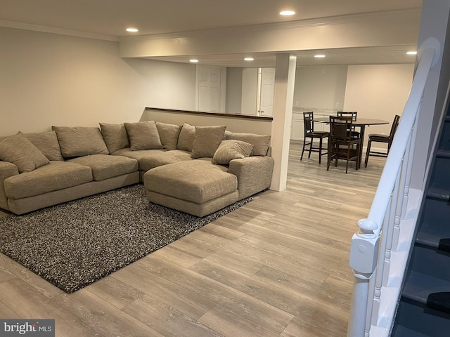 living room with wood-type flooring and ornamental molding