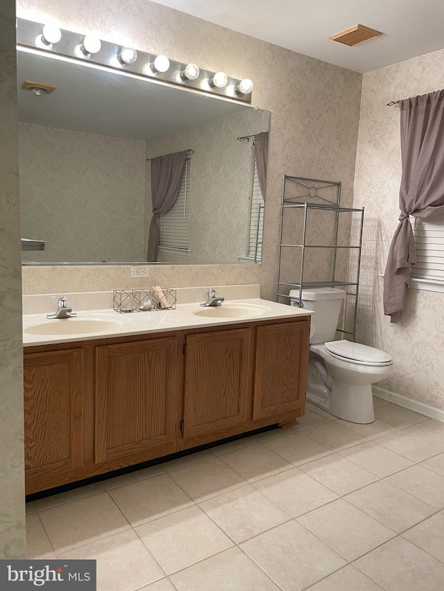 bathroom with vanity, tile patterned floors, and toilet