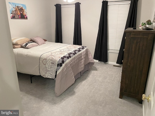 bedroom with light colored carpet