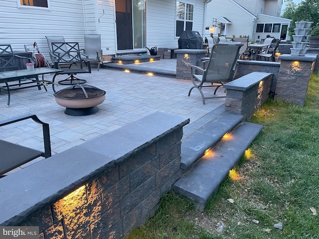 view of patio / terrace featuring a fire pit