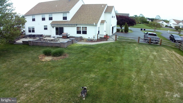 rear view of house with a yard and a patio