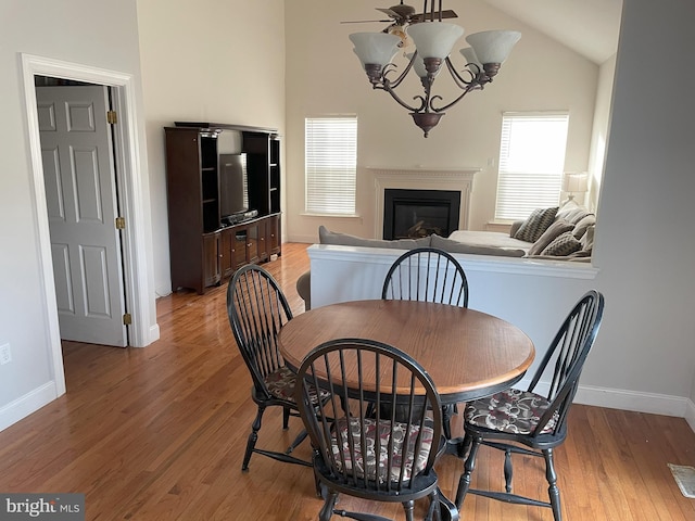 dining space featuring lofted ceiling and hardwood / wood-style flooring