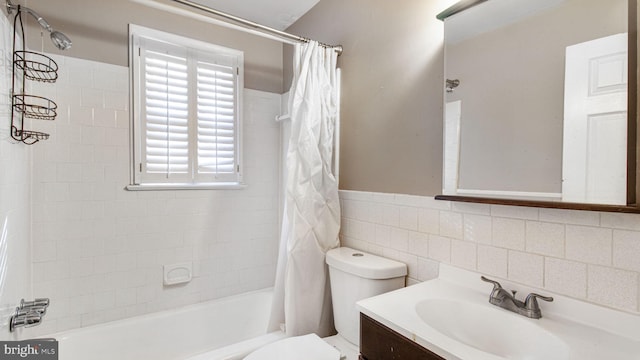 full bathroom featuring vanity, toilet, tile walls, and shower / bath combo with shower curtain