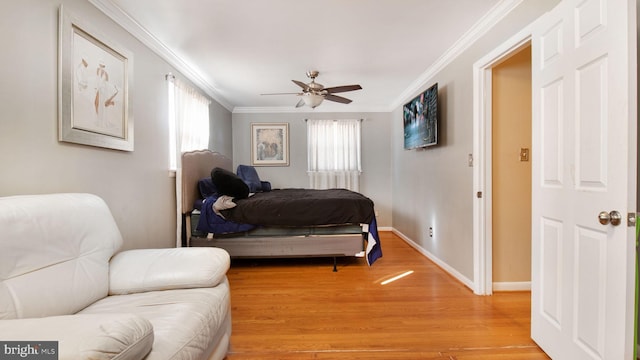 bedroom featuring crown molding, light hardwood / wood-style flooring, and ceiling fan