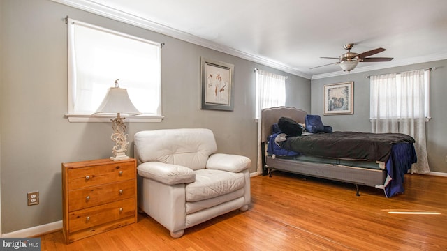 bedroom with ornamental molding, light hardwood / wood-style floors, and ceiling fan