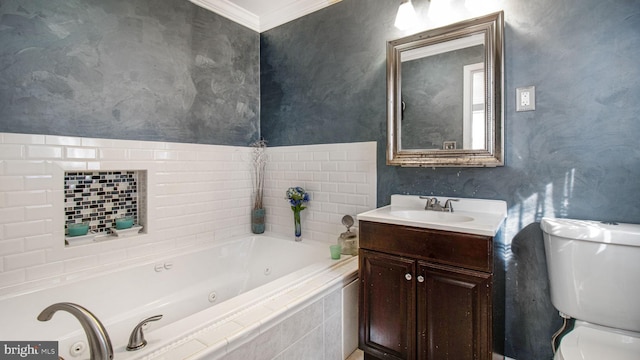 bathroom featuring ornamental molding, vanity, toilet, and tiled tub