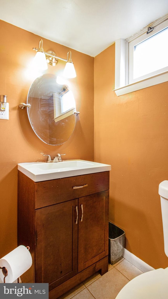 bathroom featuring vanity, toilet, and tile patterned flooring