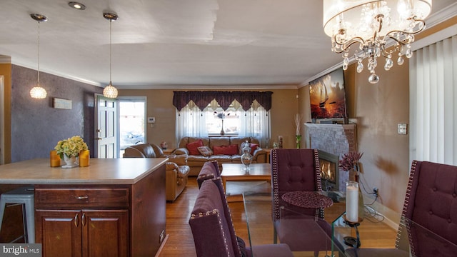 dining area with crown molding, wood-type flooring, and a chandelier