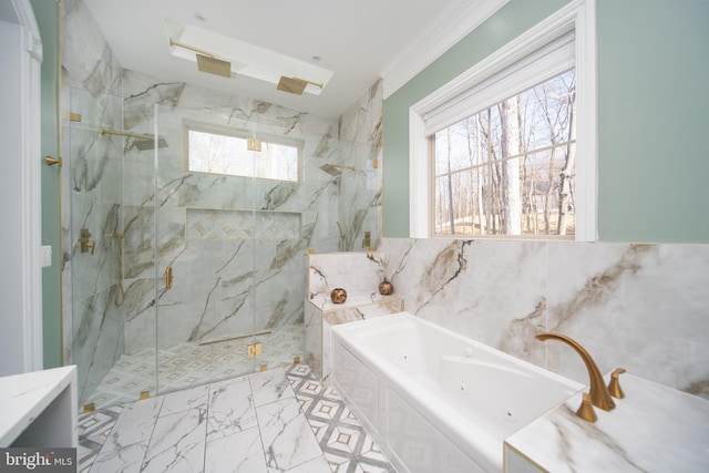 bathroom with marble finish floor, a tub with jets, a marble finish shower, and tile walls