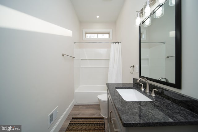 bathroom featuring toilet, wood finished floors, vanity, visible vents, and shower / bathtub combination with curtain