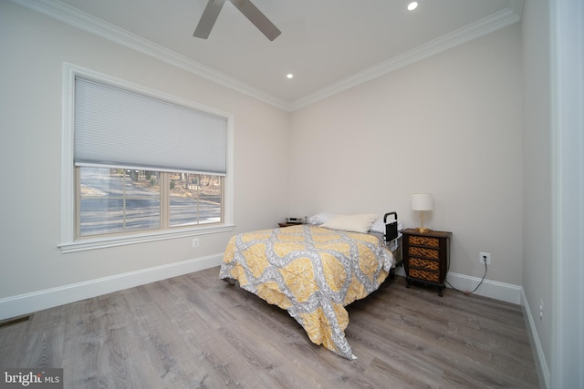 bedroom featuring recessed lighting, wood finished floors, visible vents, baseboards, and ornamental molding