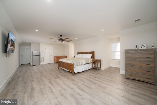 unfurnished bedroom featuring visible vents, baseboards, light wood-style flooring, freestanding refrigerator, and recessed lighting