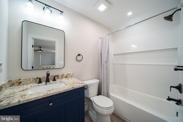 full bath featuring wood finished floors, shower / bath combo, vanity, and toilet