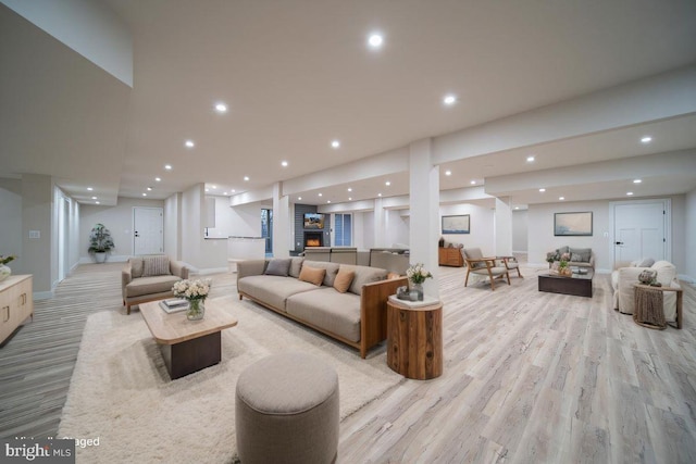 living room with light wood-style flooring, baseboards, and recessed lighting