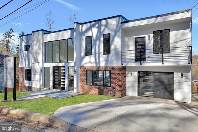 contemporary house featuring a garage and a balcony