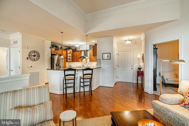 living room featuring dark hardwood / wood-style flooring and crown molding