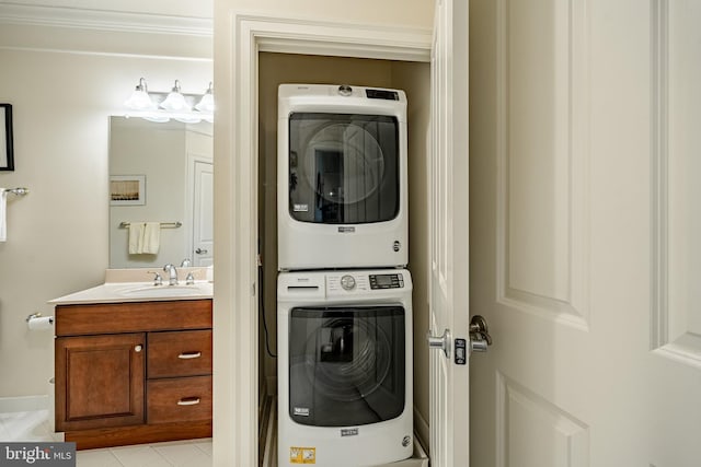 laundry room featuring sink and stacked washer and clothes dryer