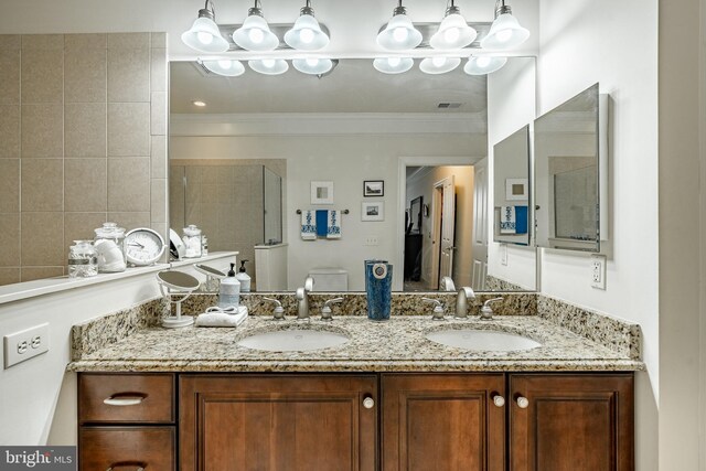 bathroom with vanity, crown molding, a shower with door, and toilet