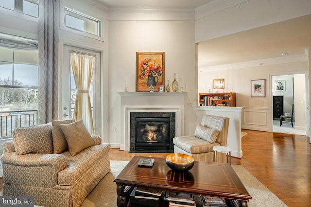 living room with crown molding and wood-type flooring