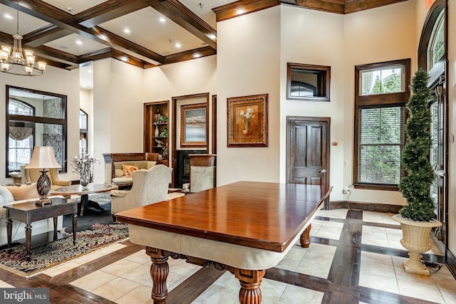 dining area with coffered ceiling, beam ceiling, and a high ceiling