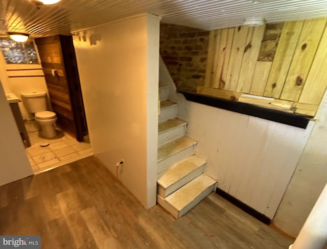 staircase featuring hardwood / wood-style floors and wooden ceiling