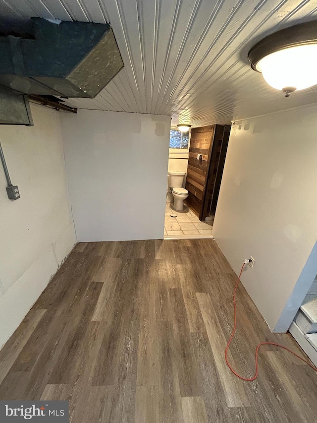 basement with hardwood / wood-style floors and wooden ceiling