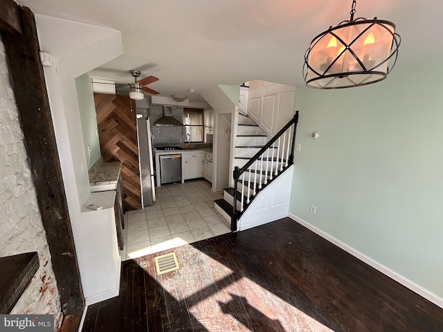 interior space featuring sink, ceiling fan, and light wood-type flooring