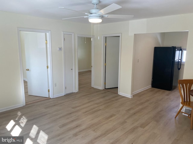 unfurnished room with ceiling fan and light wood-type flooring