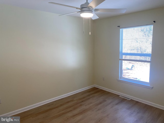 spare room with hardwood / wood-style flooring and ceiling fan