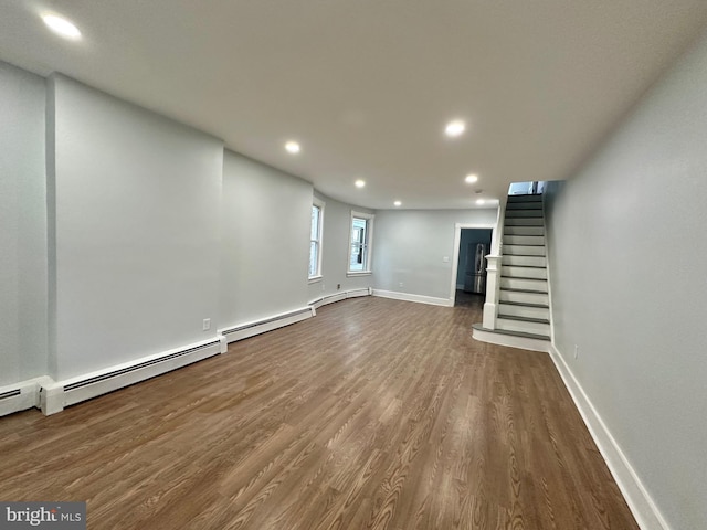 basement with wood-type flooring and a baseboard radiator