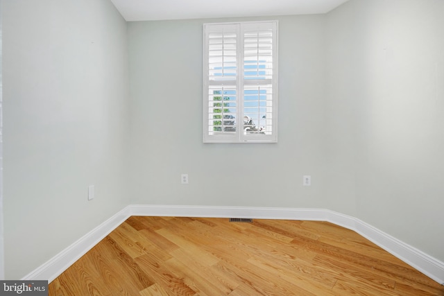 unfurnished room with hardwood / wood-style floors