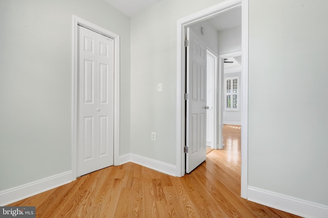 corridor with light hardwood / wood-style floors