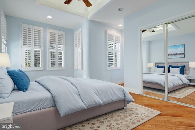 bedroom featuring hardwood / wood-style flooring, a closet, and ceiling fan