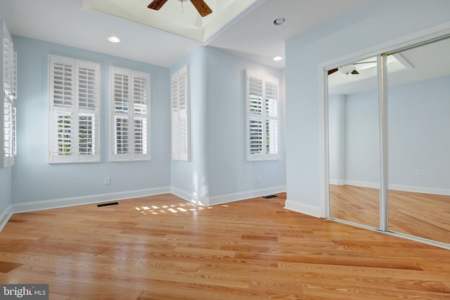 unfurnished bedroom featuring a closet, ceiling fan, and light wood-type flooring