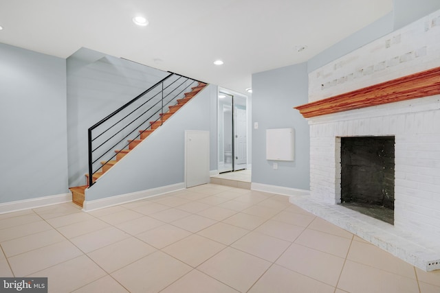 unfurnished living room featuring light tile patterned floors and a fireplace