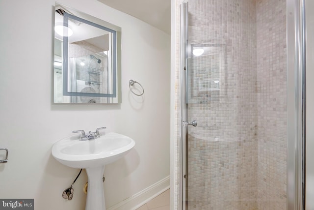 bathroom featuring a shower with door and tile patterned floors